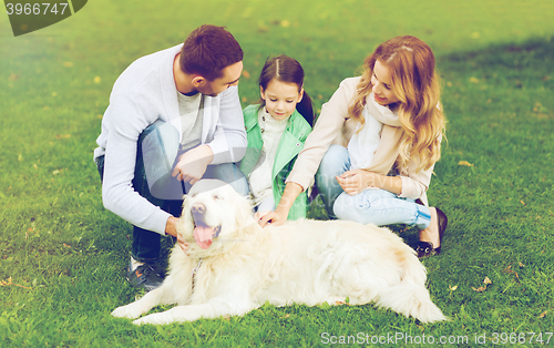 Image of happy family with labrador retriever dog in park