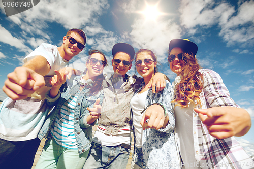 Image of smiling teenagers in sunglasses hanging outside