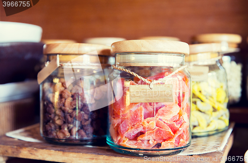 Image of close up of jars with dried fruits at grocery