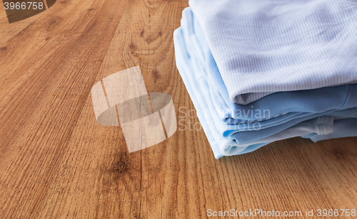 Image of close up of baby boys clothes for newborn on table