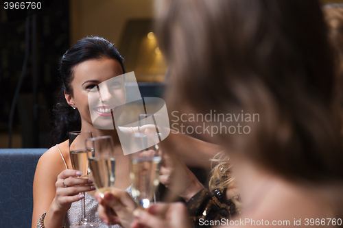 Image of happy women with champagne glasses at night club