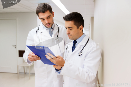 Image of two male doctors with clipboard at hospital