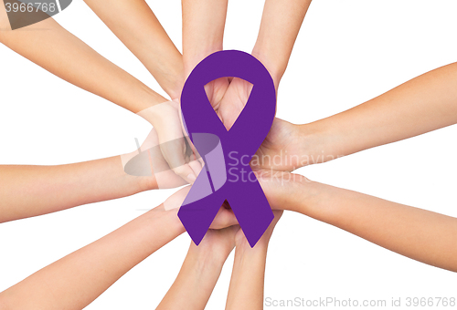 Image of close up of hands with aids and hiv awareness ribbon