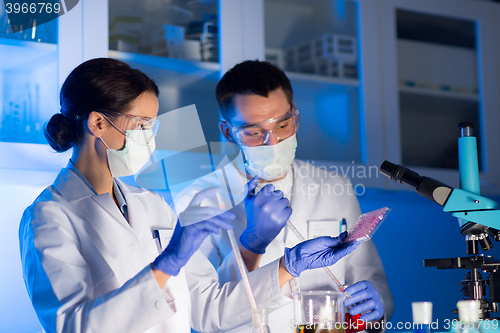 Image of close up of scientists making test in lab