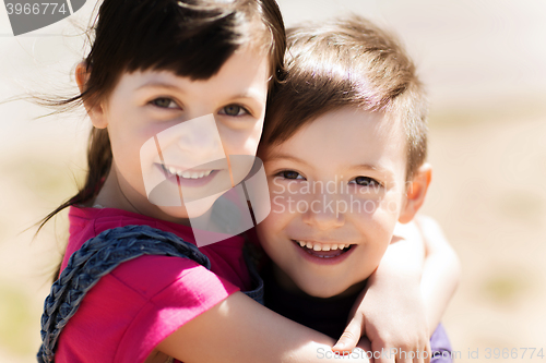 Image of two happy kids hugging outdoors