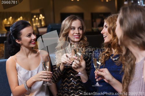 Image of happy women with champagne glasses at night club