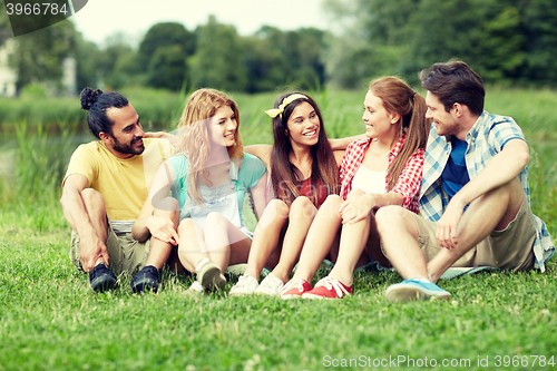 Image of group of smiling friends talking outdoors