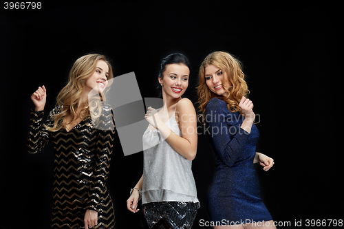 Image of happy young women dancing at night club disco