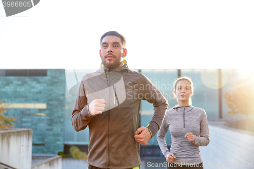 Image of happy couple running upstairs on city stairs