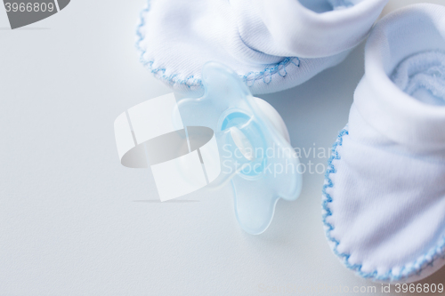 Image of close up of baby bootees and soother for newborn