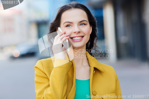 Image of smiling young woman or girl calling on smartphone