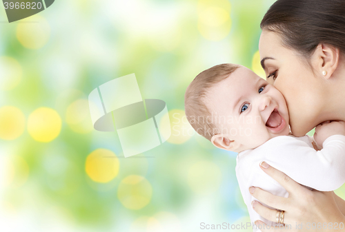 Image of happy mother kissing adorable baby