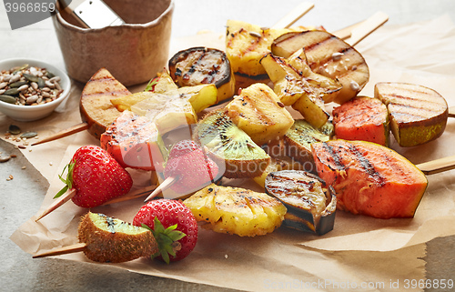 Image of grilled fruit pieces on wooden skewers