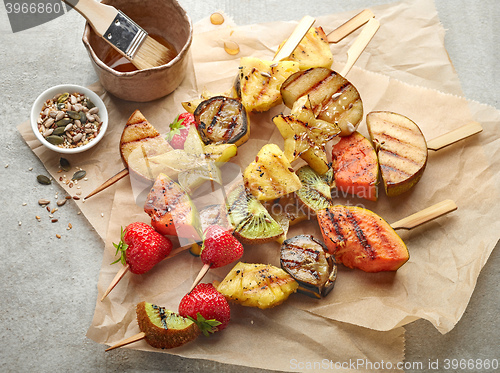 Image of grilled fruit pieces on wooden skewers