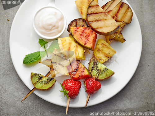 Image of grilled fruits on wooden skewers