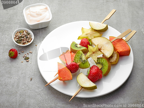 Image of fresh berries and fruit pieces on skewers