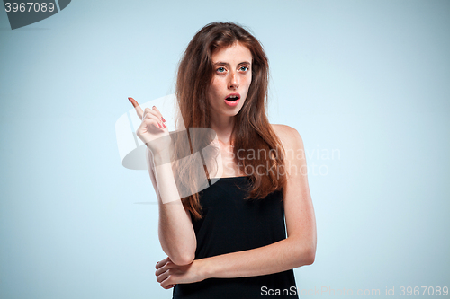 Image of Portrait of young woman with shocked facial expression