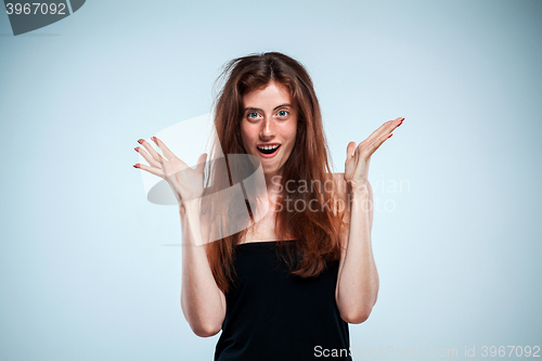 Image of Portrait of young woman with shocked facial expression