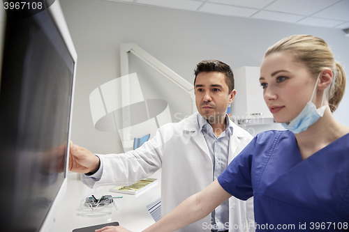 Image of dentists with x-ray on monitor at dental clinic