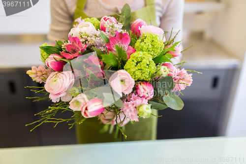 Image of close up of woman holding bunch at flower shop