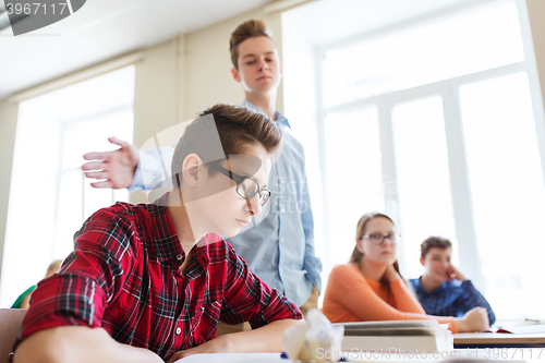 Image of classmate offending student boy at school