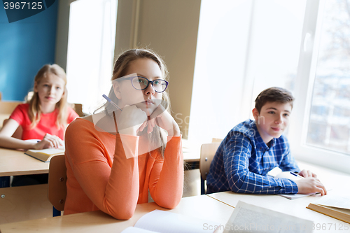 Image of group of students with notebooks at school lesson