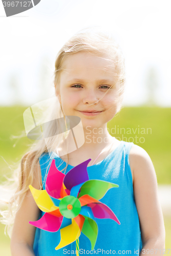 Image of happy little girl with colorful pinwheel at summer