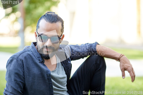 Image of man in sunglasses at city street or park