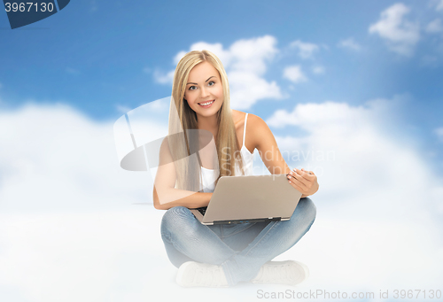 Image of young woman sitting with laptop