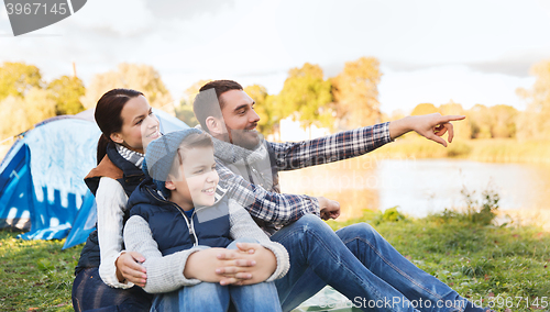 Image of happy family with tent at camp site