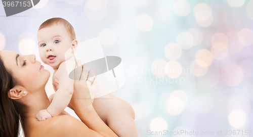 Image of happy mother holding adorable baby