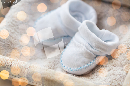 Image of close up of baby bootees for newborn boy in basket
