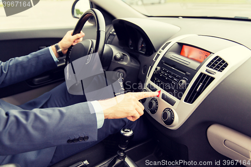 Image of close up of man driving car and emergency button