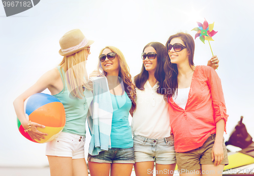 Image of smiling girls in shades having fun on the beach