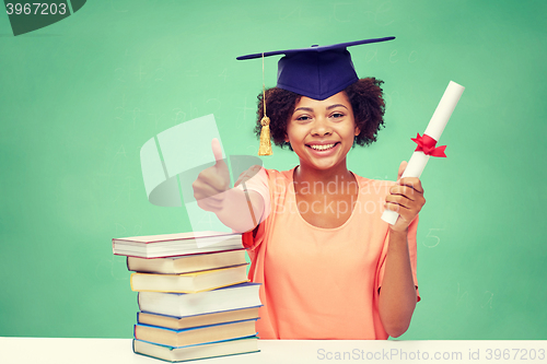 Image of happy african bachelor girl with books and diploma