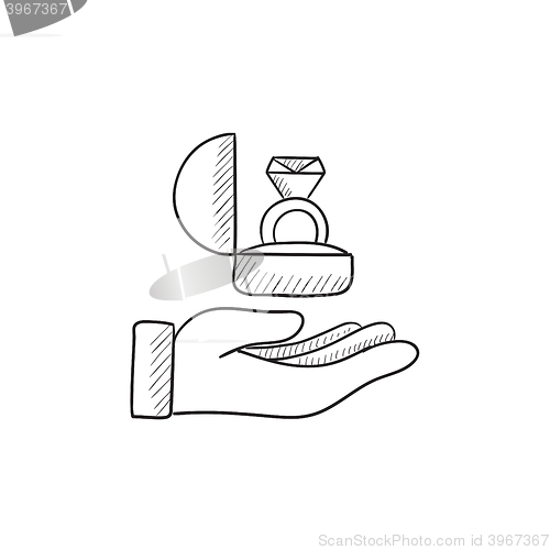 Image of Hand holding gift box with ring sketch icon.