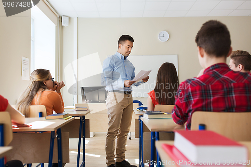 Image of group of students and teacher with test results