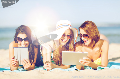 Image of girls with tablet pc on the beach