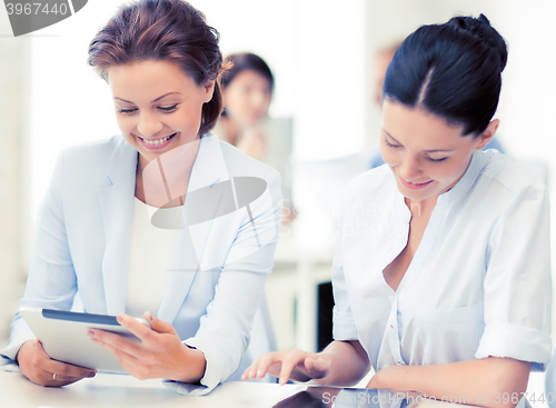 Image of business team working with tablet pc in office