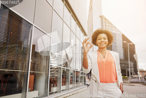 Image of happy young african american businesswoman in city