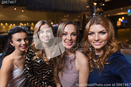 Image of happy smiling women taking selfie at night club