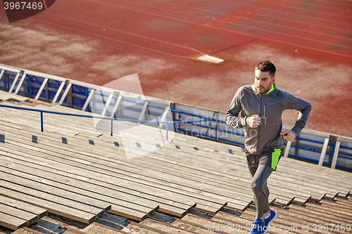 Image of young man running upstairs on stadium