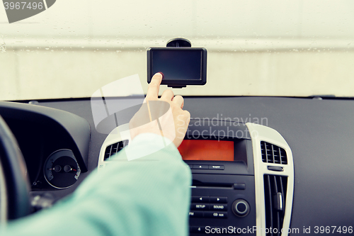 Image of close up of man with gps navigator driving car