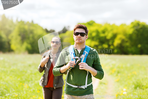 Image of couple with backpacks hiking outdoors