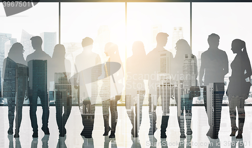 Image of people silhouettes over window and city background