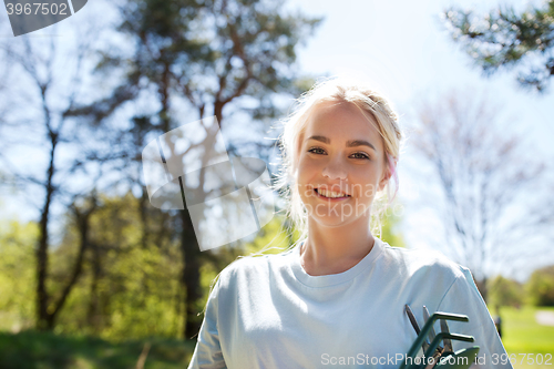 Image of happy young volunteer woman outdoors