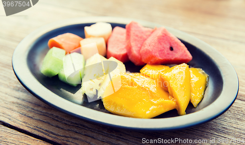 Image of plate of fresh juicy fruits at asian restaurant