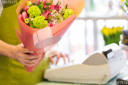 Image of close up of florist with bunch at flower shop