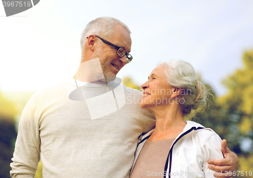 Image of senior couple hugging in city park