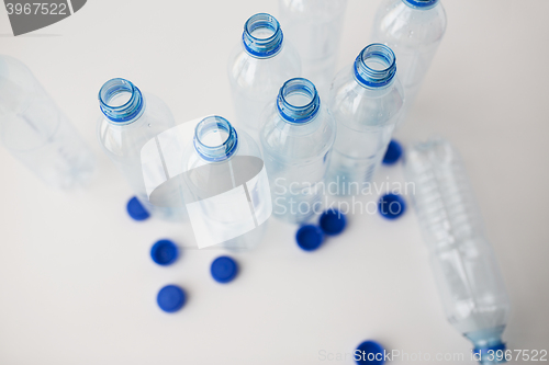 Image of close up of empty water bottles and caps on table